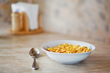 bowl of  corn flakes and spoon