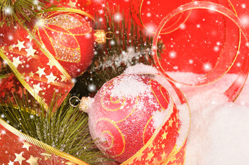 Two decorative red Christmas balls on a snowy scene