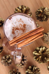 Hot chocolate with cinnamon sticks, cones covered with glitter