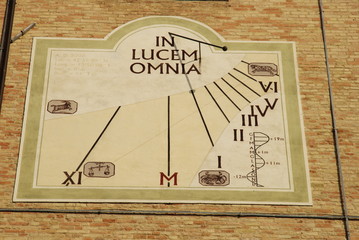 sundial on the wall of a church in Monteprandone, Italy