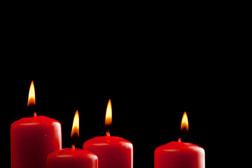 four red candles over black