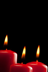 four red candles over black