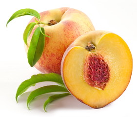 Ripe peach fruit with leaves and slises