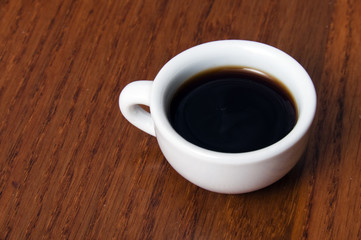 Small porcelain cup with coffee