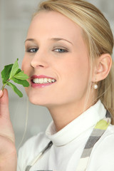 woman smelling a mint leave