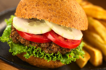 Vegetarian lentil burger in wholewheat bun with fries