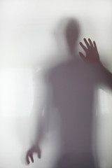 Obraz premium Person stood behind frosted glass