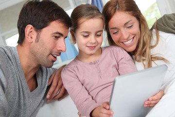 Family using electronic tablet at home