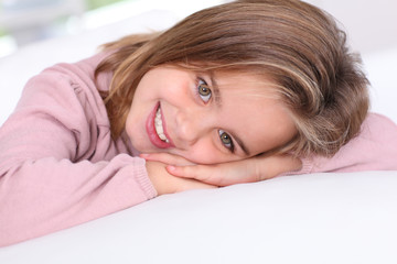 Portrait of cute little girl with hands on chin © goodluz