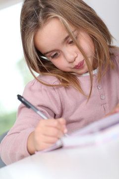 Portrait of grade-schooler doing homework