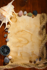 old paper, compass and rope on a wooden table