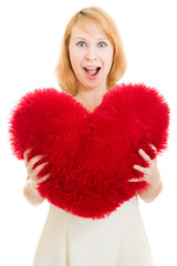 Surprised girl with a heart on a white background.