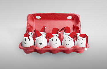 Group of happy eggs dressed in Santa-Claus red-white hats