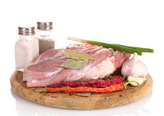 Raw meat and vegetables on a wooden board isolated on whitе