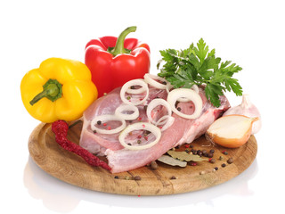 Raw meat and vegetables on a wooden board isolated on whitе