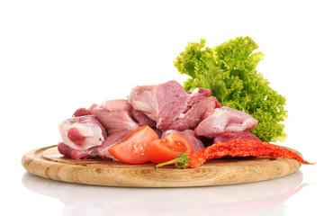 Pieces of raw meat and vegetables