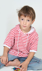 young boy playing with toys over white