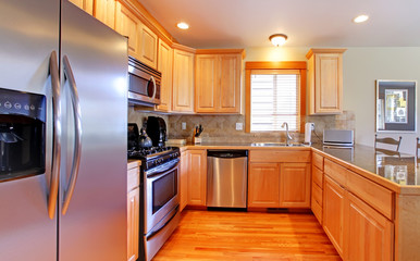 KItchen with maple cabinets and new stainless steal appliances.