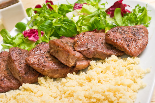 Tenderloin steaks in wine sauce with cadamon and kuskus groats
