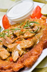 Traditional hungarian potato pancake with goulash