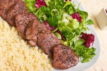 Tenderloin steaks in wine sauce with cadamon and kuskus groats