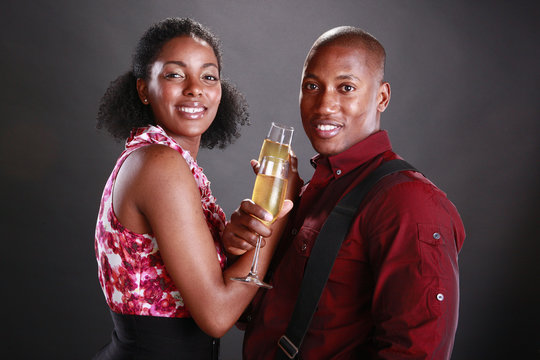 An African American Couple Cheers With Champagne Flutes