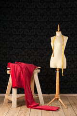 tailor mannequin with red piece of cloth