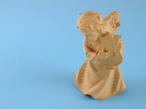 Christmas angel with harf on a blue background