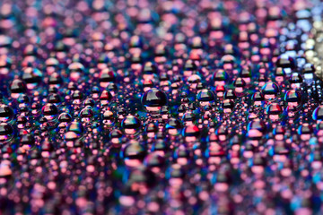 water drops on dark disk surface