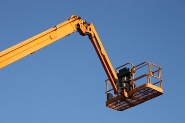 The Arm and Platform of a Yellow Cherry Picker.