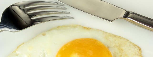 Fork, knife and fried egg