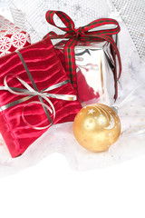 Several wrapped Christmas gifts with silvery background