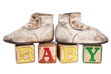 Vintage baby boots and blocks isolated on white