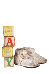 Vintage baby boots and blocks isolated on white
