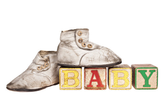 Vintage baby boots and blocks isolated on white