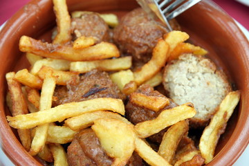 Meatballs in tomato sauce with fries Spain