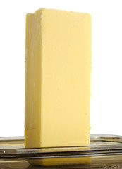 Stick of Butter on Glass Butterdish Against White Background
