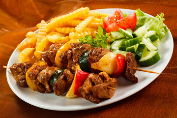 Grilled meat, French fries and vegetables