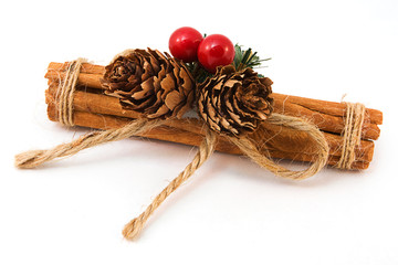 Festive Cinnamon stick decoration over white