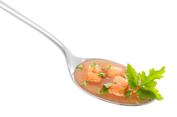 Vegetable soup in a spoon on white background