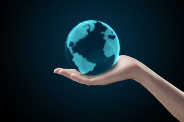 Conceptual symbol of the Earth with human hand.