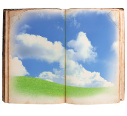 Open book green grass clouds