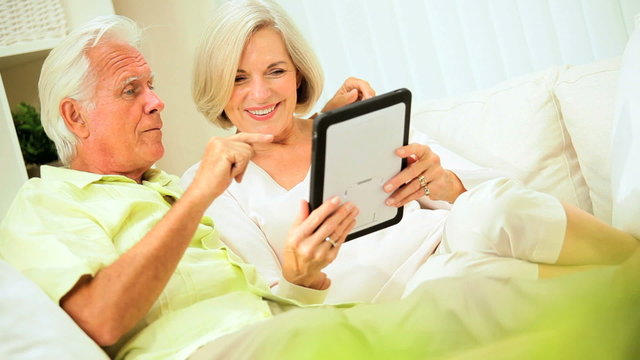 Retired Couple Using Wireless Tablet Technology