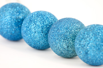 Christmas theme with blue balls on a white background