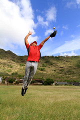 Fototapeta premium Baseball player jumps high to catch a ball