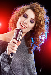 Rock star.Sexy Girl singing in retro mic