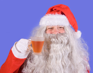 Obraz na płótnie Canvas Santa Claus holding a teacup
