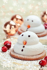 Two marshmallow snowmen biscuits with Christmas decorations