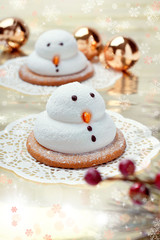 Two marshmallow snowmen biscuits with Chistmas decorations