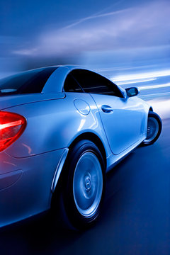Fototapeta Fast Sports Car with Motion Blur